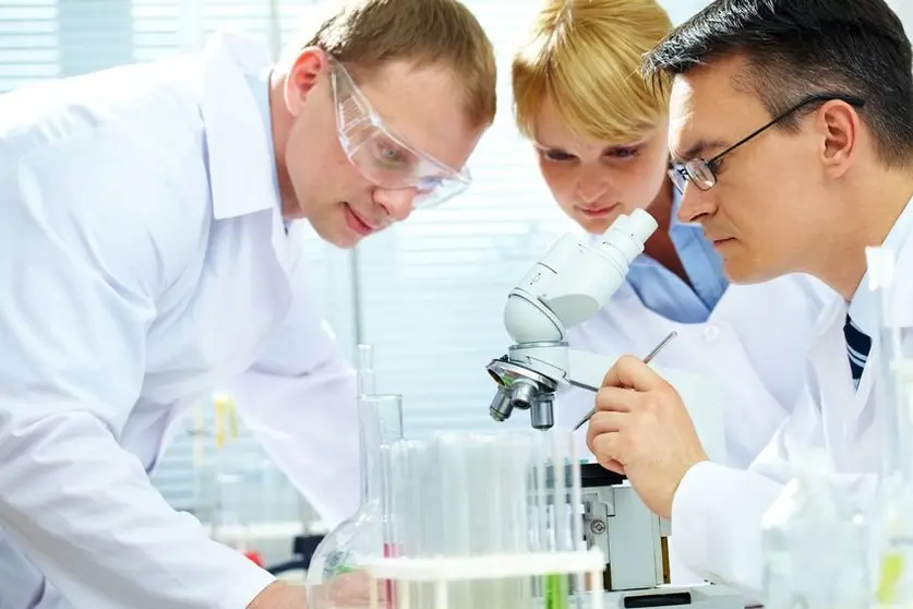 10362527 - team of chemists making experiments in laboratory
