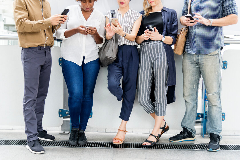 Group of diverse people using smartphones