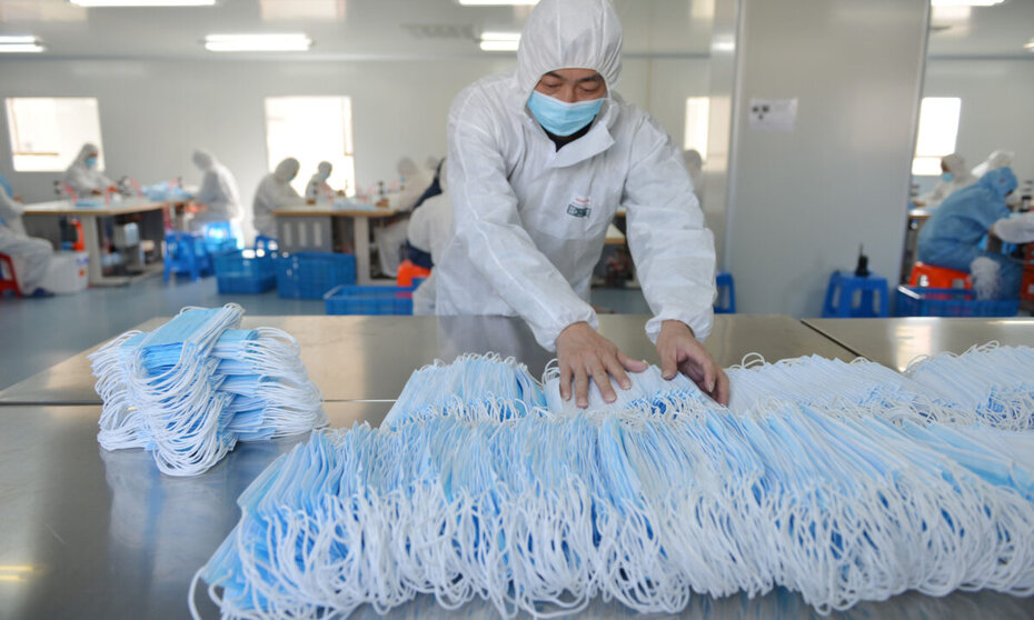 This photo taken on February 18, 2020 shows a worker sorting face masks being produced to satisfy increased demand during China's COVID-19 coronavirus outbreak, at a factory in Nanjing, in China's Jiangsu province. - The medical equipment factory switched surgical instruments and dental equipment production lines to a mask production line to meet the increased demand. (Photo by STR / AFP) / China OUT (Photo by STR/AFP via Getty Images)